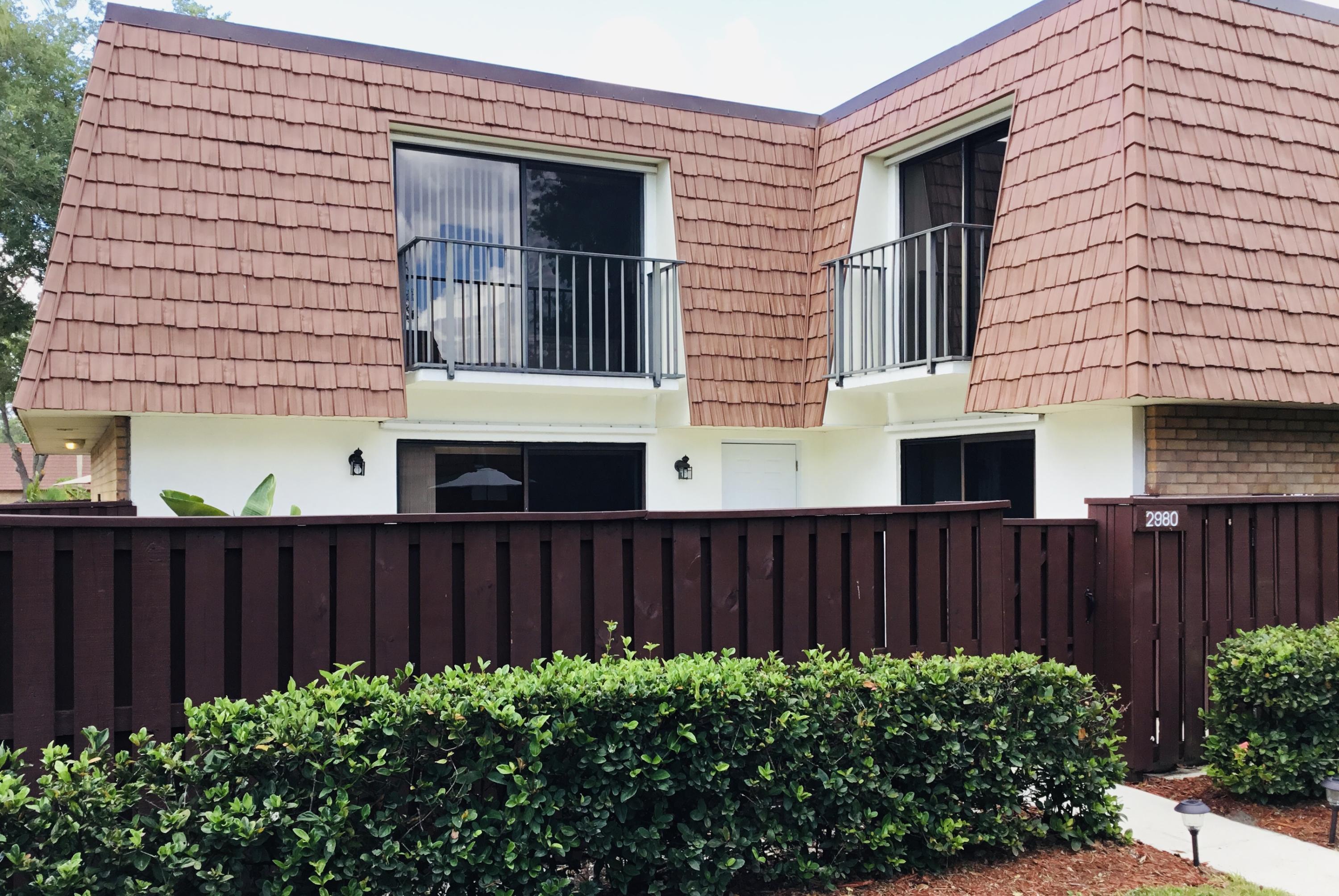 2980 Southwest Sunset Trace Circle Palm City, FL 34990 - Photo 1 of 21 a front view of a house with a garden