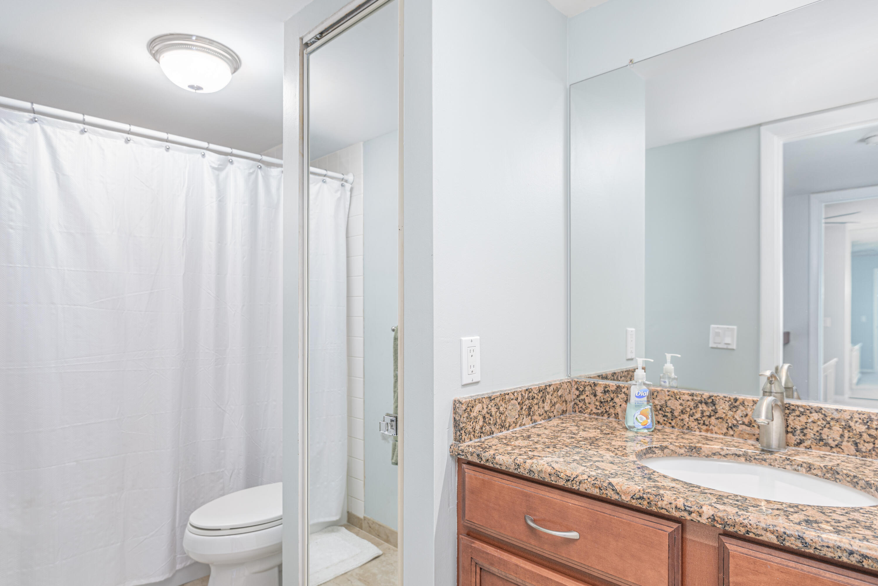 2980 Southwest Sunset Trace Circle Palm City, FL 34990 - Photo 13 of 21 a bathroom with a granite countertop sink and a mirror
