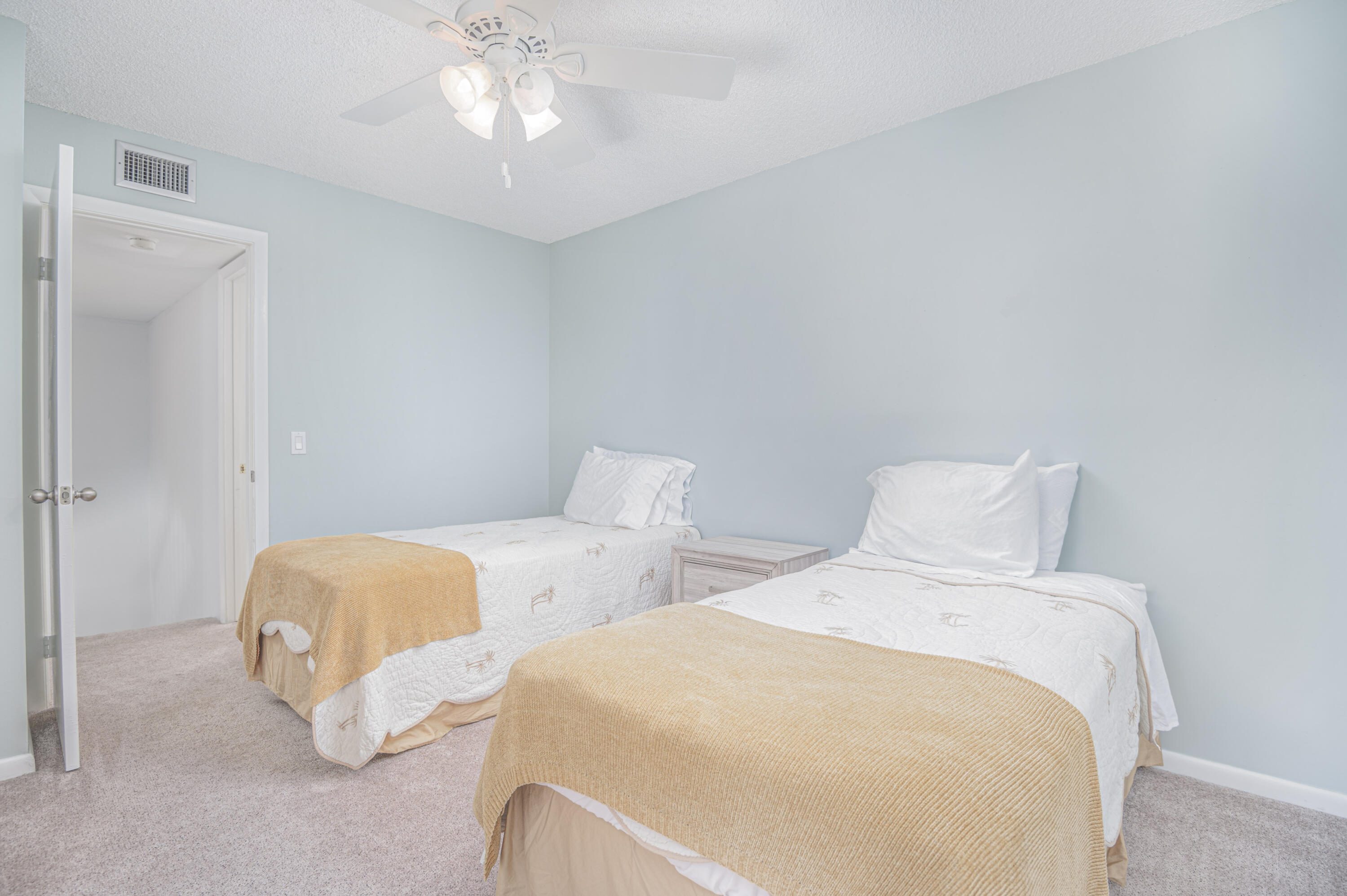 2980 Southwest Sunset Trace Circle Palm City, FL 34990 - Photo 14 of 21 a bedroom with two beds and a chandelier