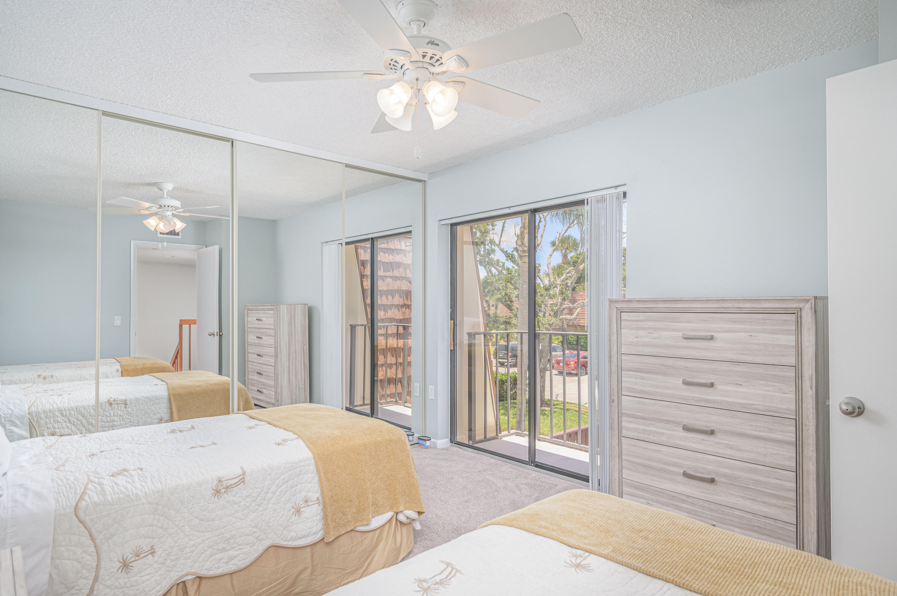 2980 Southwest Sunset Trace Circle Palm City, FL 34990 - Photo 15 of 21 a spacious bedroom with a large bed and a chandelier