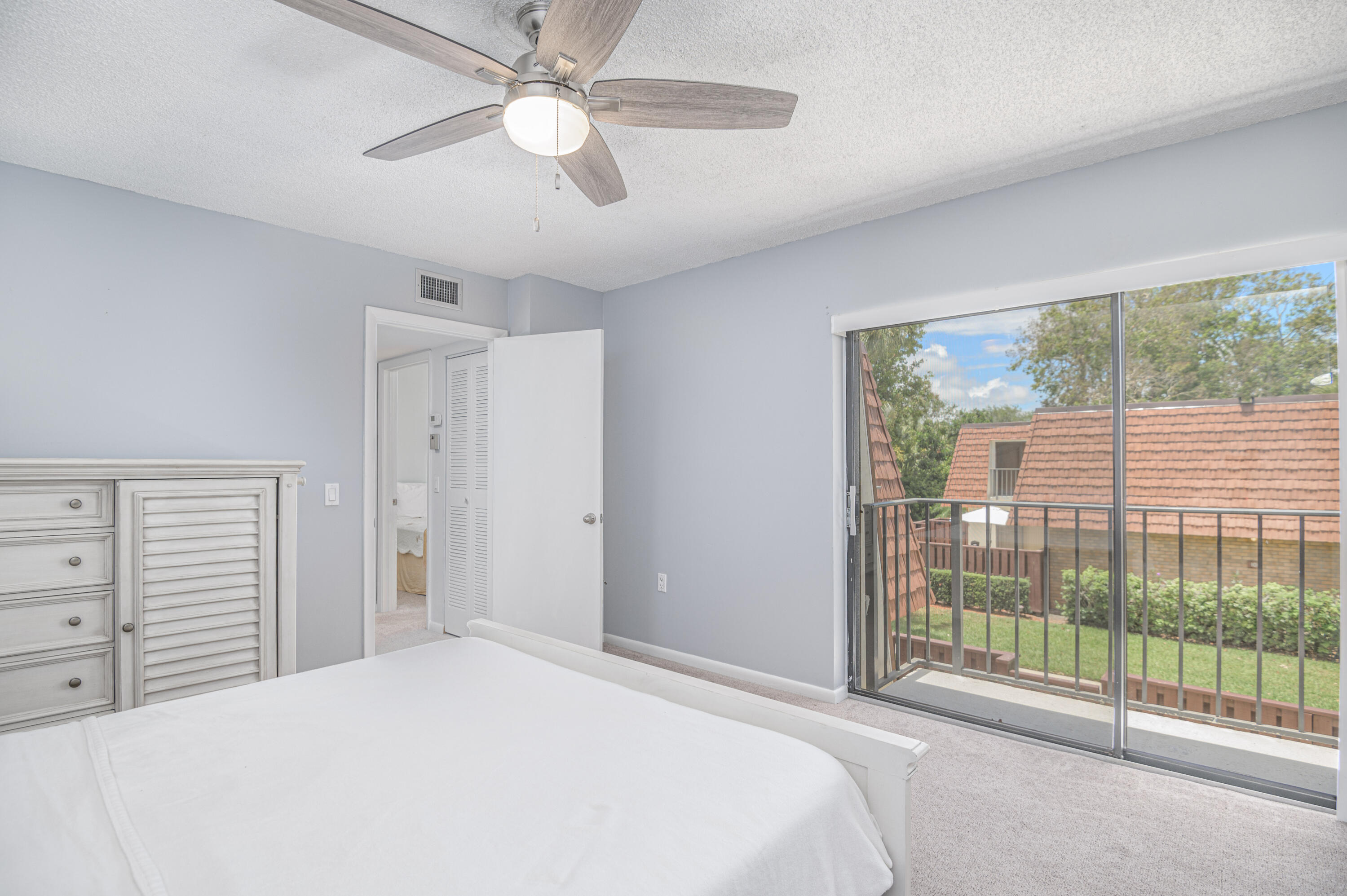 2980 Southwest Sunset Trace Circle Palm City, FL 34990 - Photo 16 of 21 a bedroom with a large bed and a large window