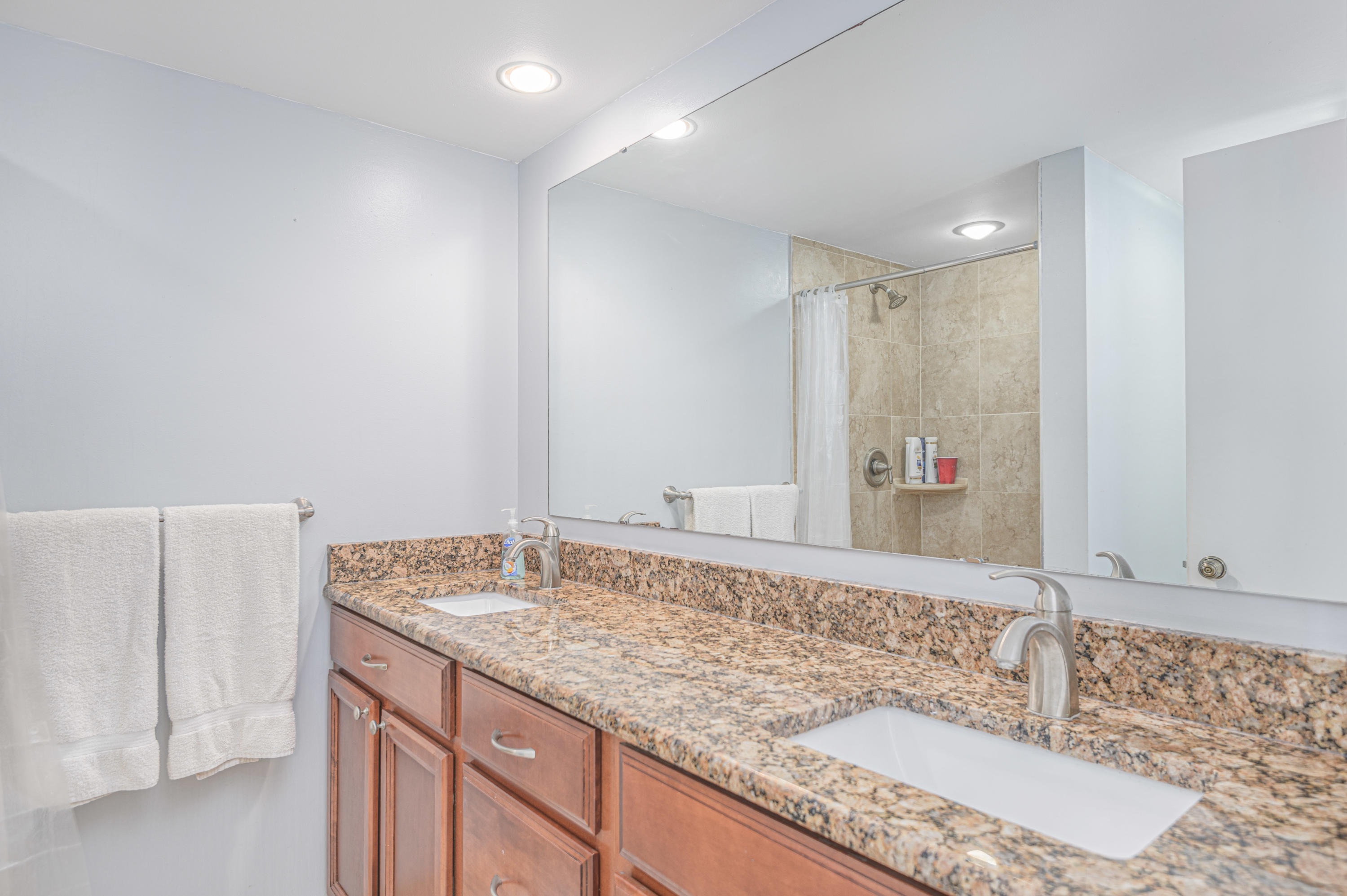 2980 Southwest Sunset Trace Circle Palm City, FL 34990 - Photo 19 of 21 a bathroom with a granite countertop sink and a mirror