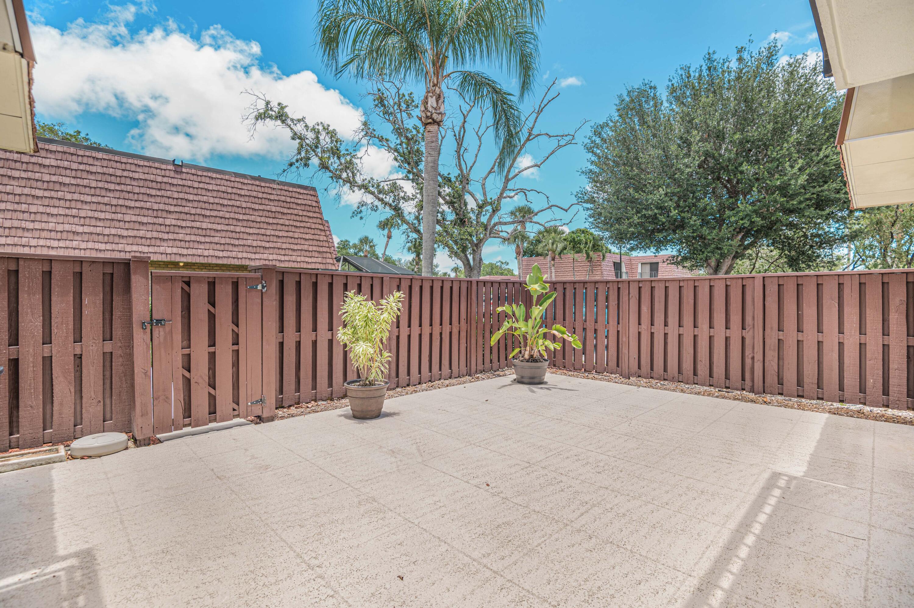 2980 Southwest Sunset Trace Circle Palm City, FL 34990 - Photo 4 of 21 a view of backyard with a deck and wooden fence