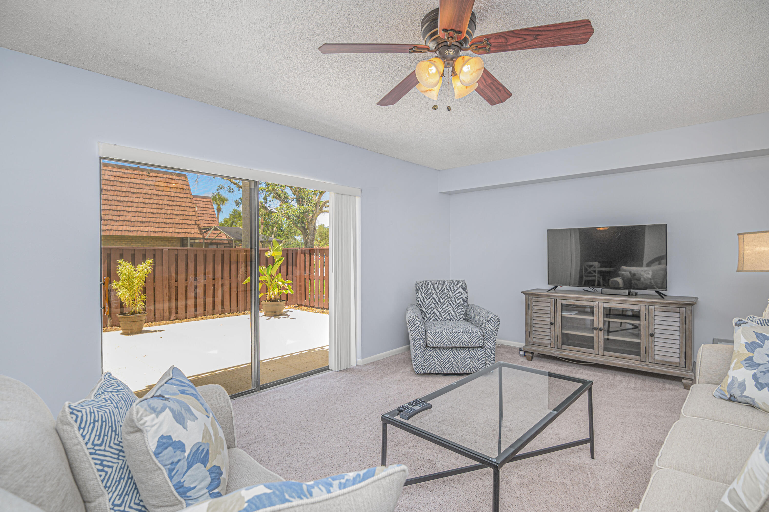 2980 Southwest Sunset Trace Circle Palm City, FL 34990 - Photo 5 of 21 a living room with furniture and a flat screen tv