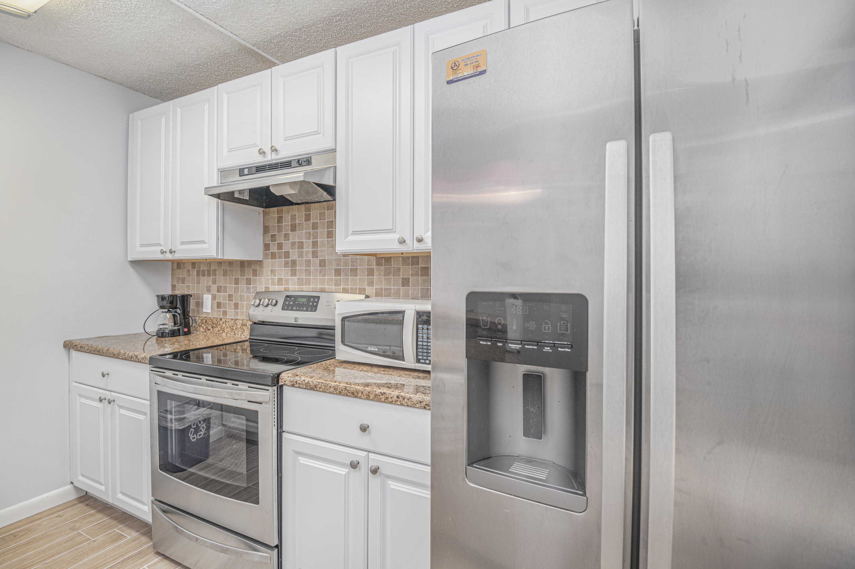 2980 Southwest Sunset Trace Circle Palm City, FL 34990 - Photo 8 of 21 a kitchen with appliances a sink and cabinets