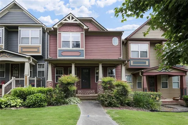 a front view of a house with porch and garden