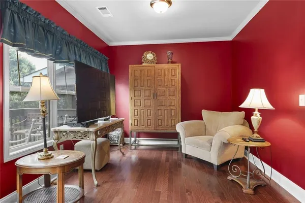 a living room with furniture a flat screen tv and a large window