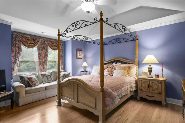 a bedroom with a bed couch and a window