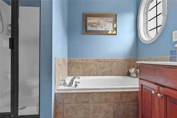 a bathroom with a bathtub and shower