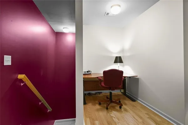 a workspace room with furniture and wooden floor