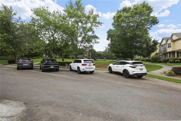 a view of a cars parked on the side of a street