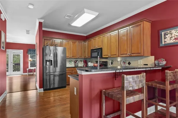 a kitchen with stainless steel appliances granite countertop a refrigerator stove microwave and sink