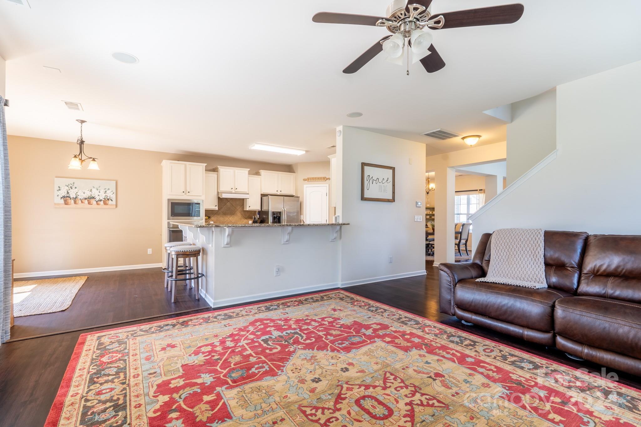 5396 Hackberry Lane Southwest Concord, NC 28027 - Photo 13 of 31 a bedroom with a bed and wooden floor