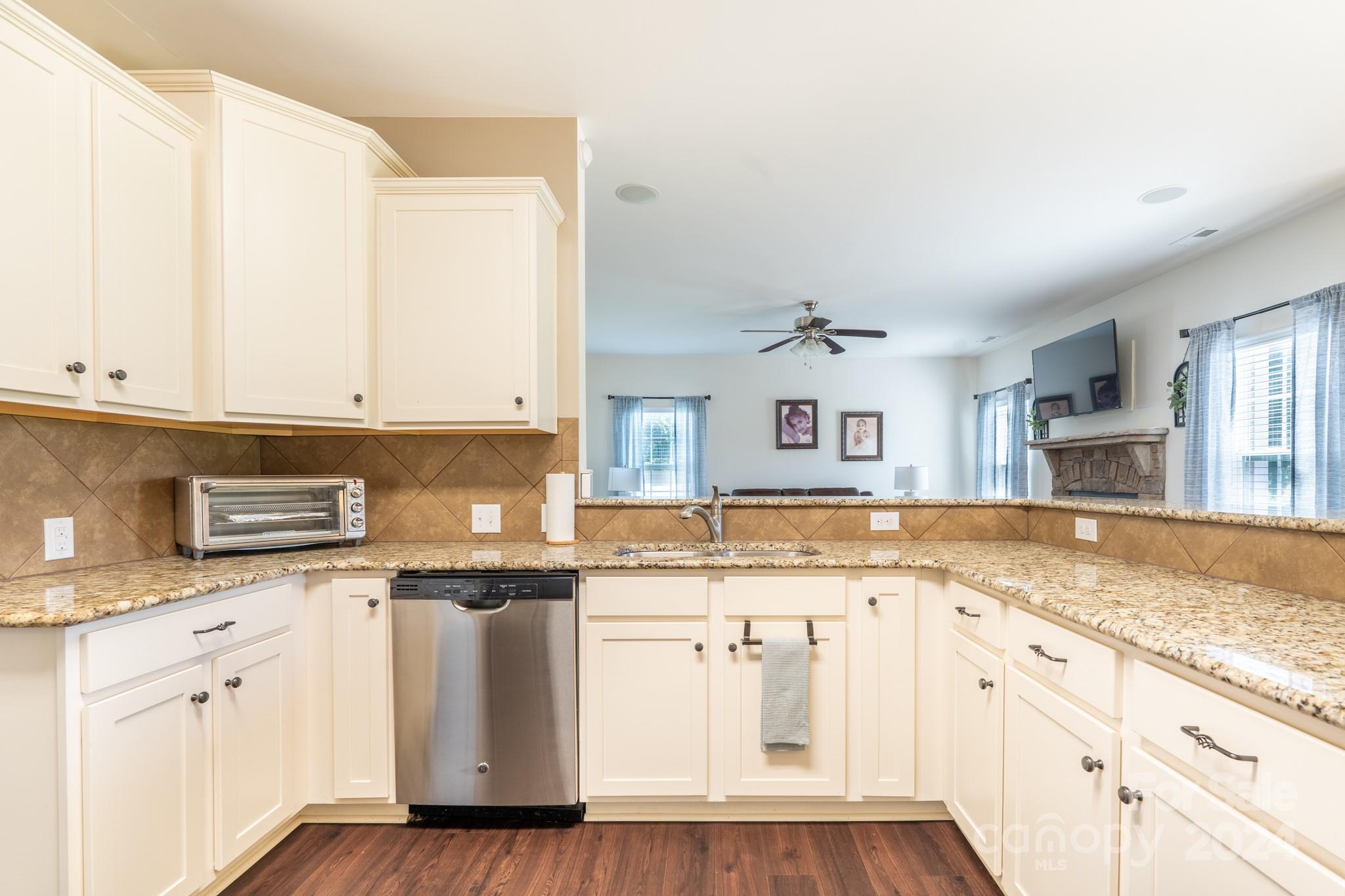 5396 Hackberry Lane Southwest Concord, NC 28027 - Photo 16 of 31 a kitchen with granite countertop cabinets stainless steel appliances and a granite counter tops