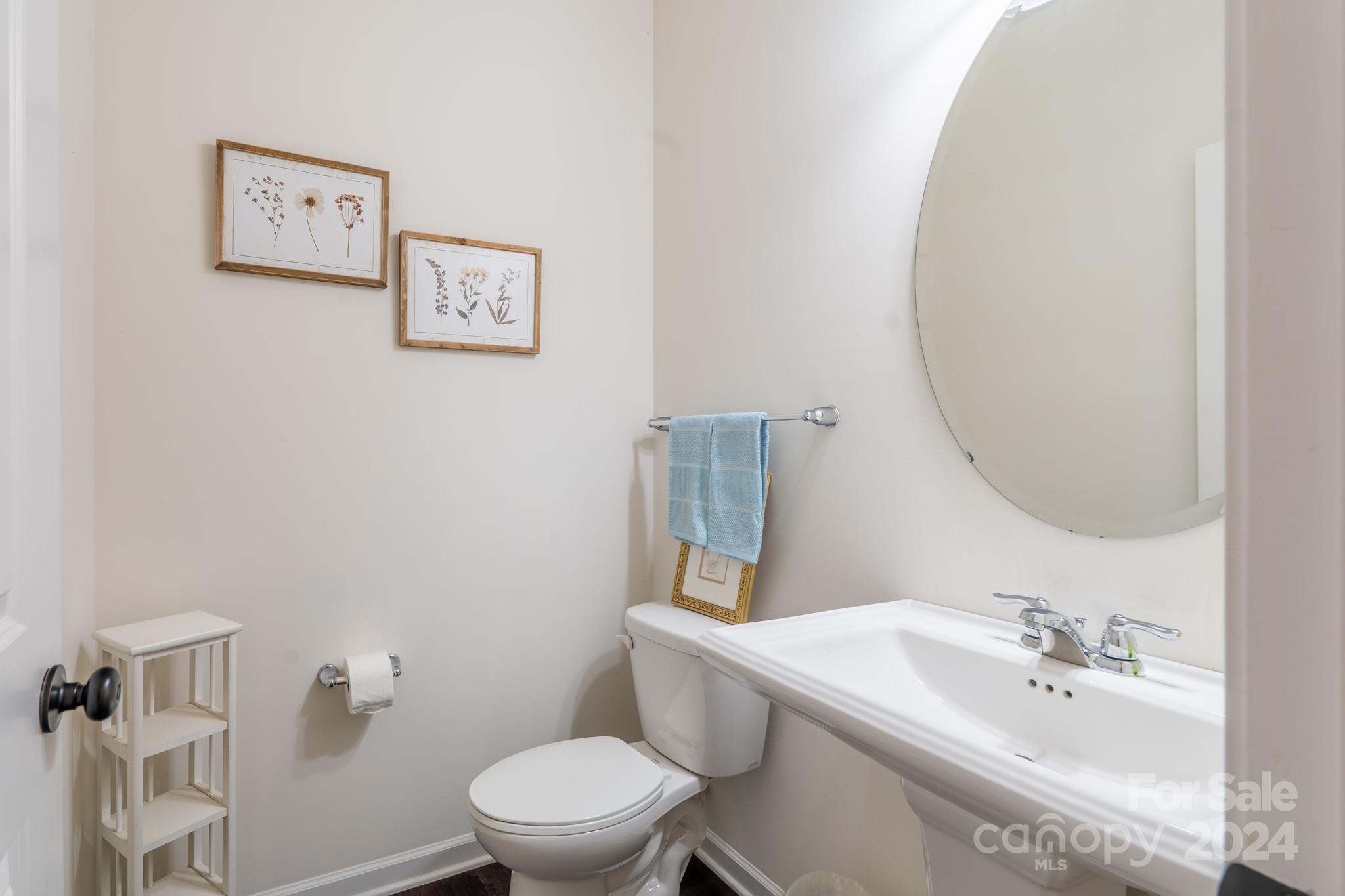 5396 Hackberry Lane Southwest Concord, NC 28027 - Photo 18 of 31 a white toilet sitting next to a bathroom sink