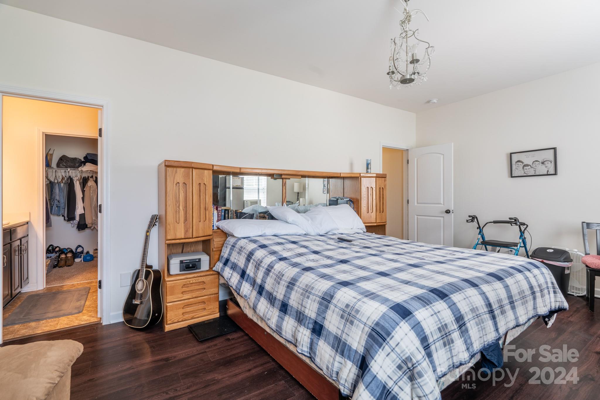 5396 Hackberry Lane Southwest Concord, NC 28027 - Photo 19 of 31 a bedroom with a bed and wooden floor