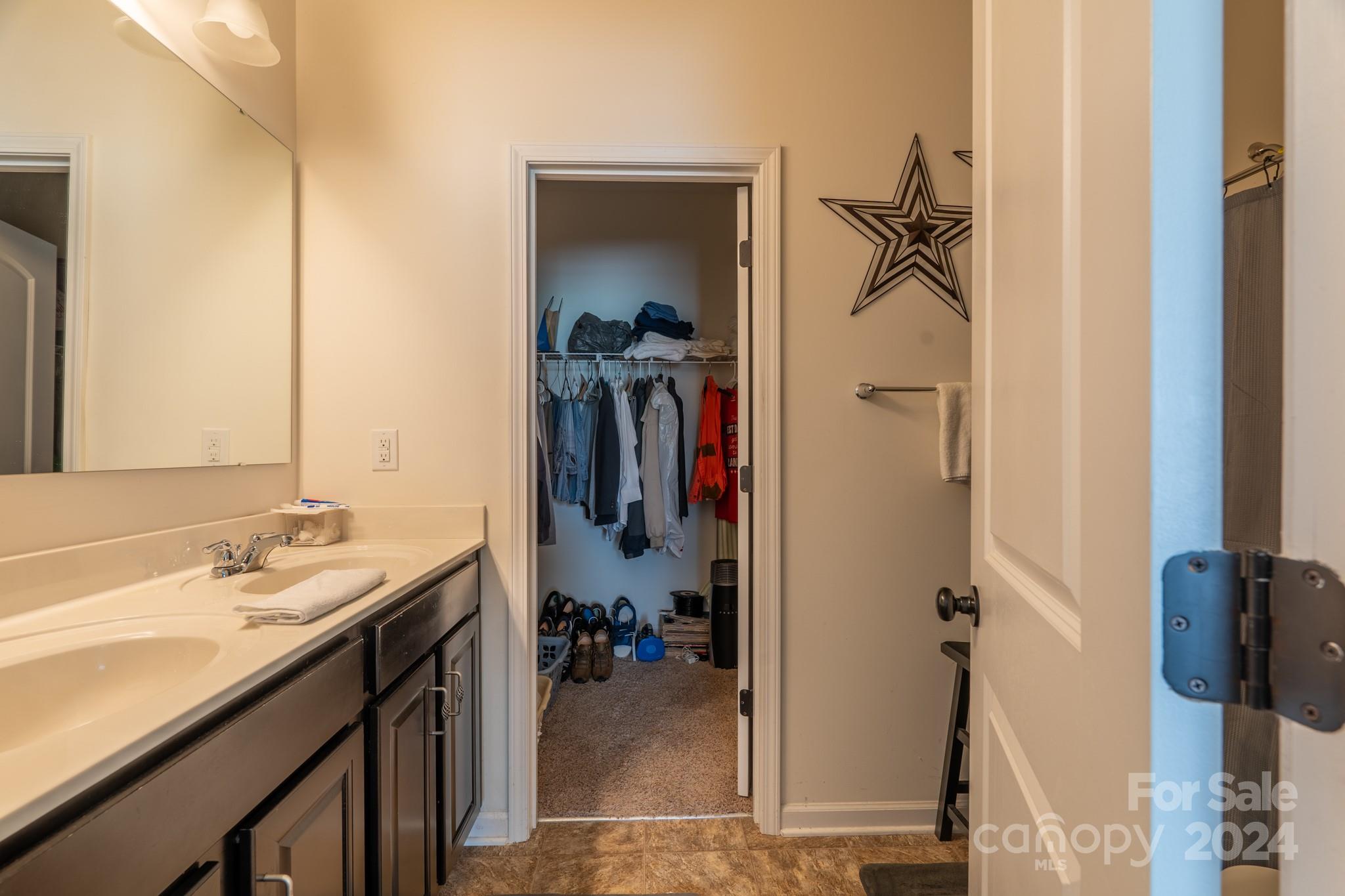 5396 Hackberry Lane Southwest Concord, NC 28027 - Photo 20 of 31 a bathroom with a sink and a mirror