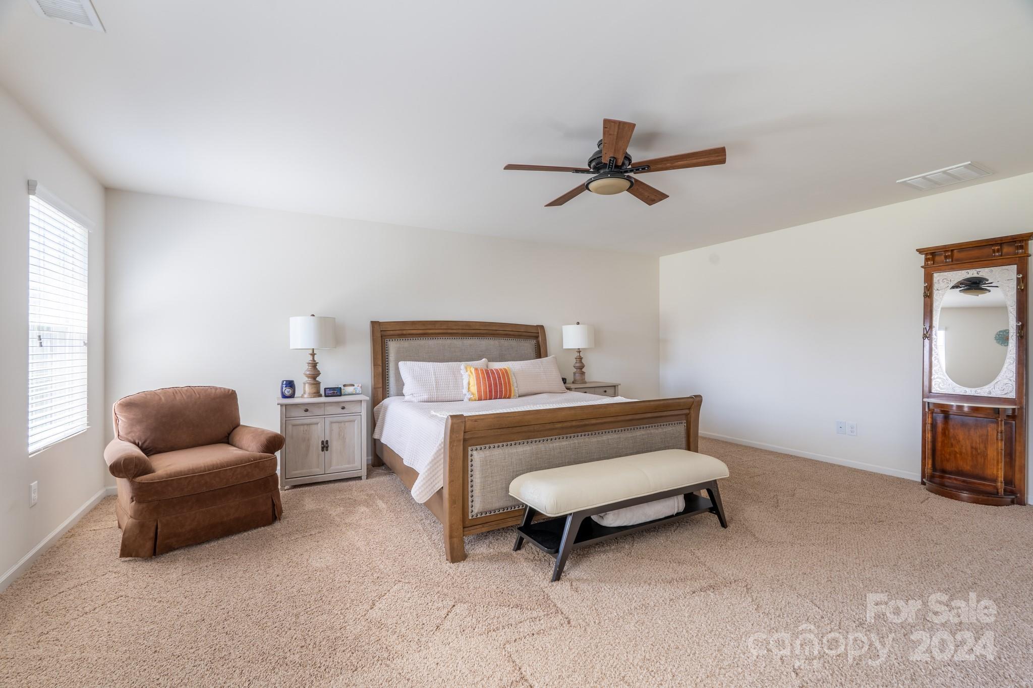 5396 Hackberry Lane Southwest Concord, NC 28027 - Photo 21 of 31 a bedroom with furniture and a couch
