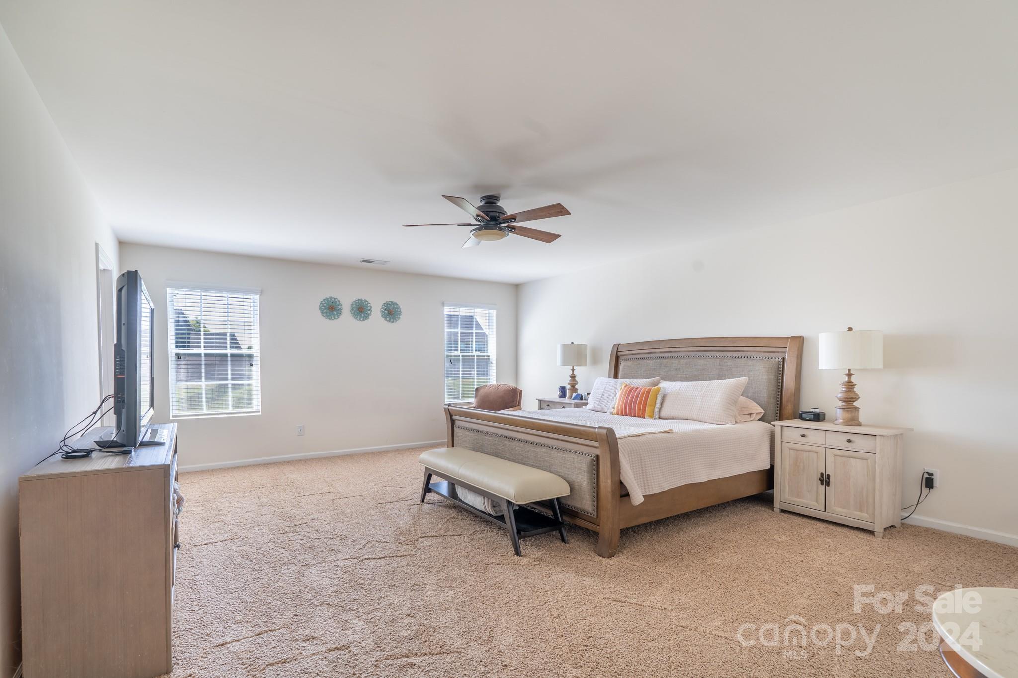 5396 Hackberry Lane Southwest Concord, NC 28027 - Photo 22 of 31 a spacious bedroom with a bed and a window