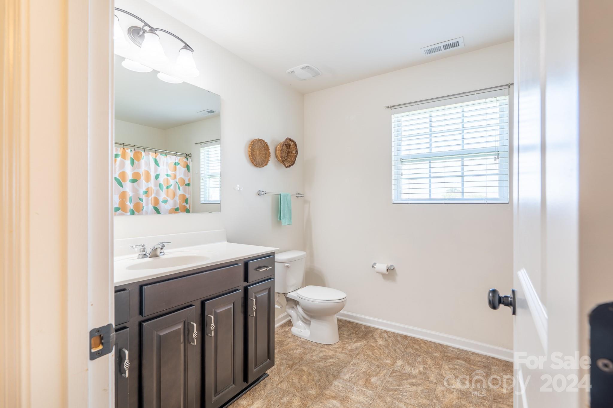 5396 Hackberry Lane Southwest Concord, NC 28027 - Photo 28 of 31 a bathroom with a sink a toilet and shower