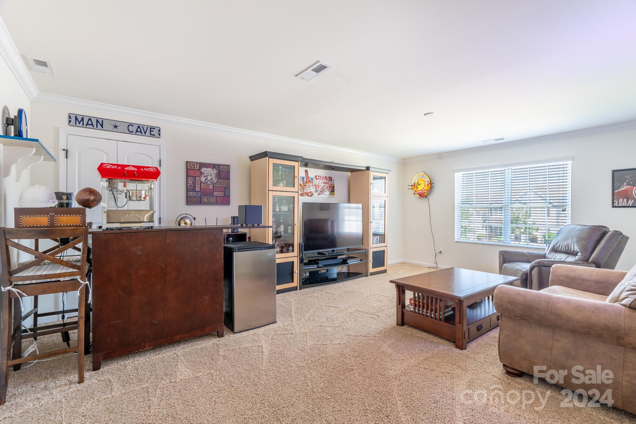 5396 Hackberry Lane Southwest Concord, NC 28027 - Photo 30 of 31 a living room with furniture and a flat screen tv