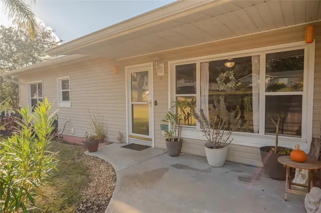 a view of a dining room with furniture a chandelier and wooden floor