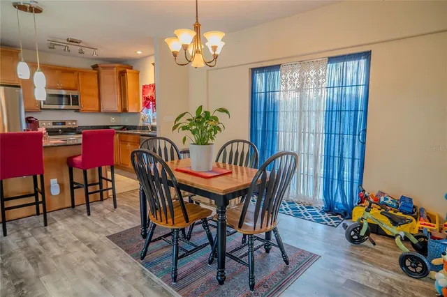 a spacious bedroom with a large bed a flat tv screen and dresser