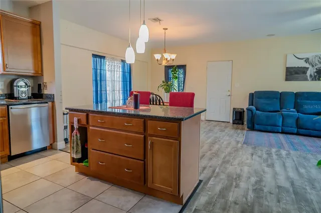 a view of a hallway with front door and wooden floor