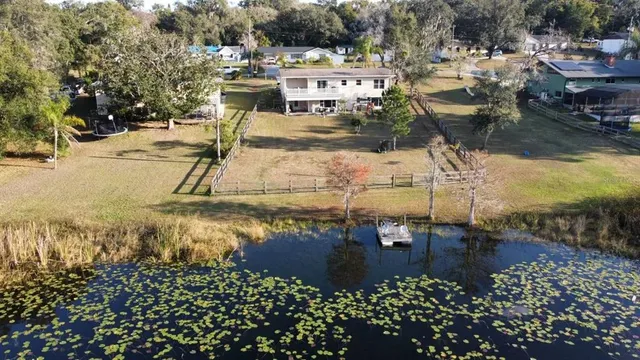 a view of a house with a swimming pool and a chairs