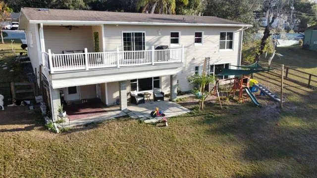a view of a house with pool and sitting area