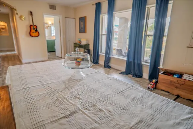 a view of a balcony with wooden chairs and lake view