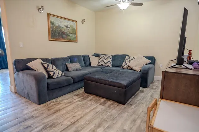 a front view of house with yard and trees in the background