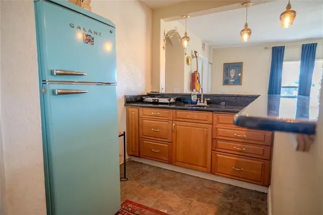 an aerial view of a house with lake view and a yard