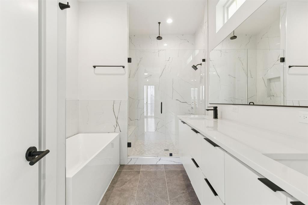 4119 Munger Avenue Dallas, TX 75204 - Photo 12 of 30 a bathroom with a bathtub and a shower