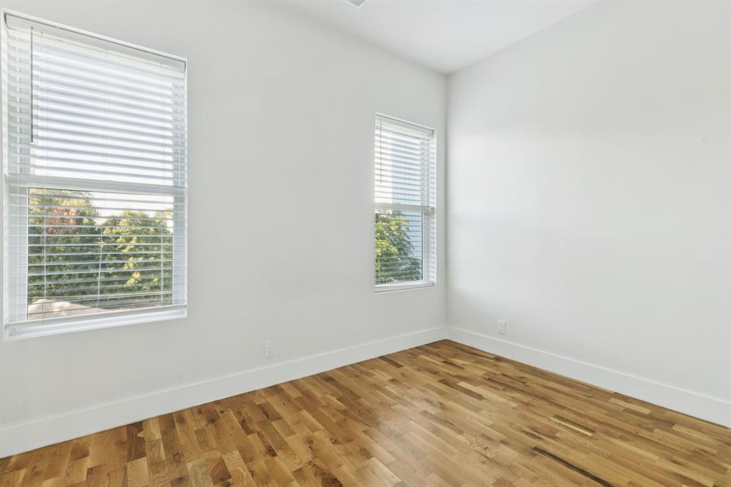 4119 Munger Avenue Dallas, TX 75204 - Photo 17 of 30 a view of an empty room with wooden floor and a window