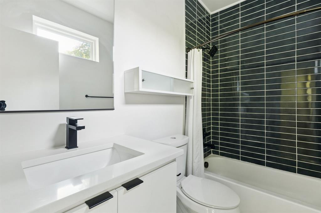 4119 Munger Avenue Dallas, TX 75204 - Photo 18 of 30 a bathroom with a sink toilet and shower