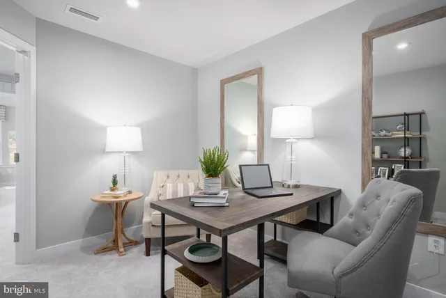a view of a dining room with a table and chairs