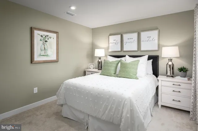 a bedroom with a bed and a night stand