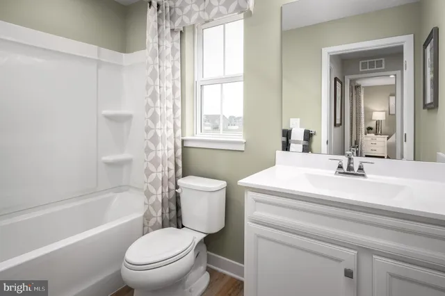 a bathroom with a granite countertop toilet a sink and a bathtub