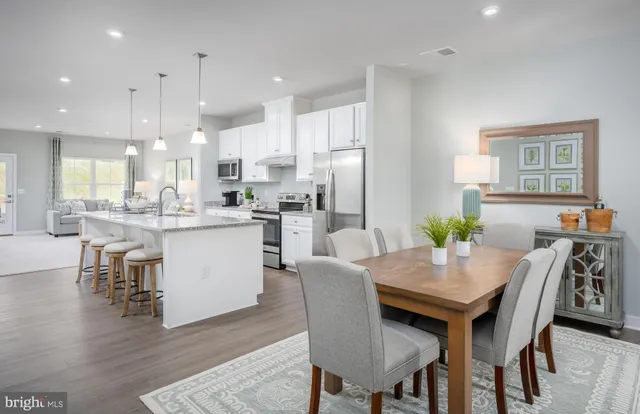 a dining room with kitchen island a table and chairs