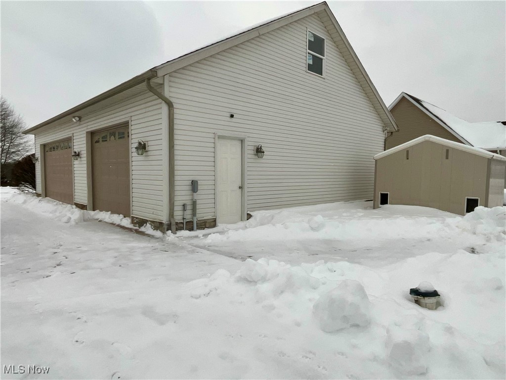 3079 Alexander Road Atwater, OH 44201 - Photo 2 of 45 View of snow covered exterior with a garage