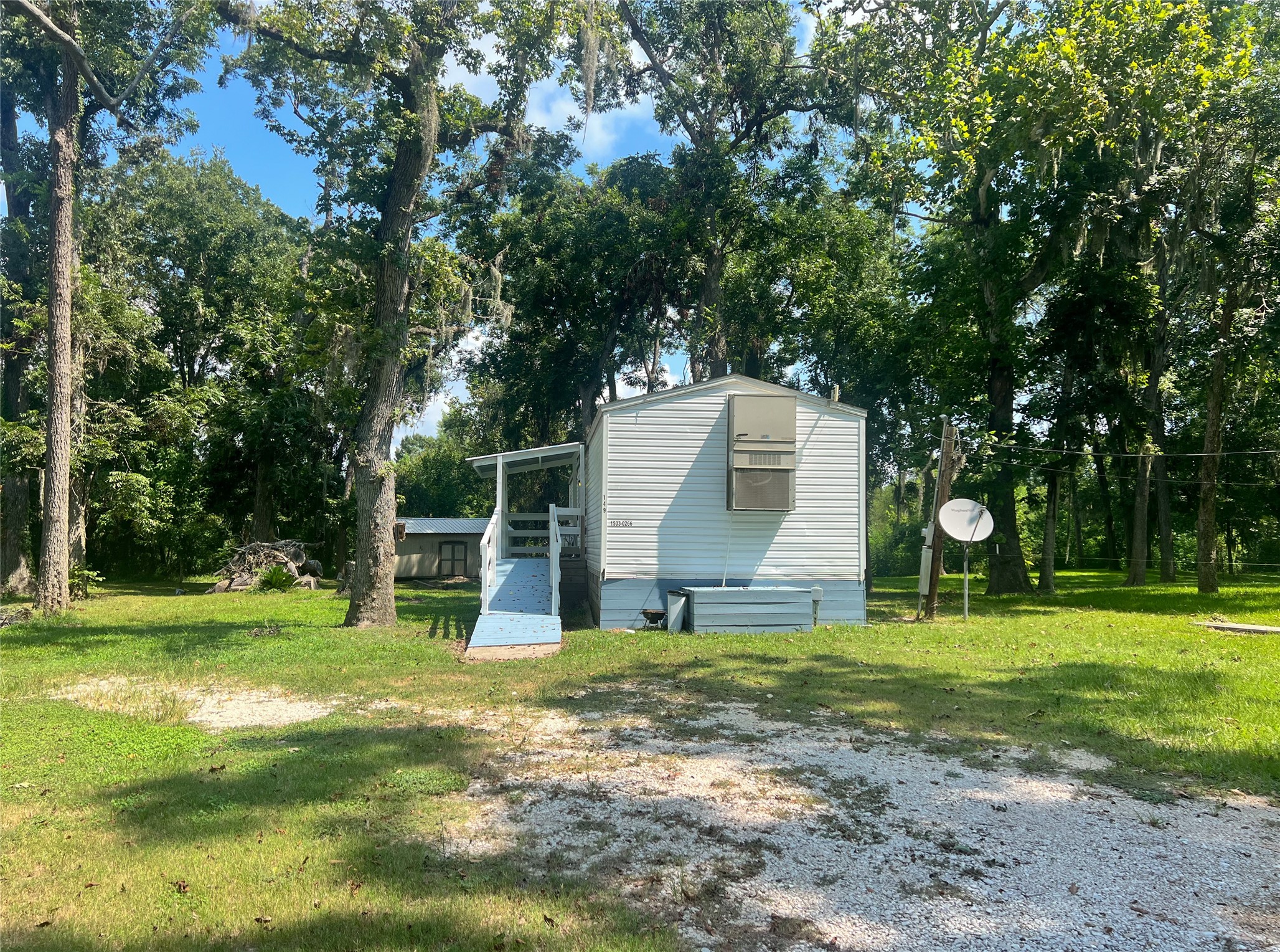 149 Devils Road Goodrich, TX 77335 - Photo 2 of 15 a backyard of a house with lots of green space