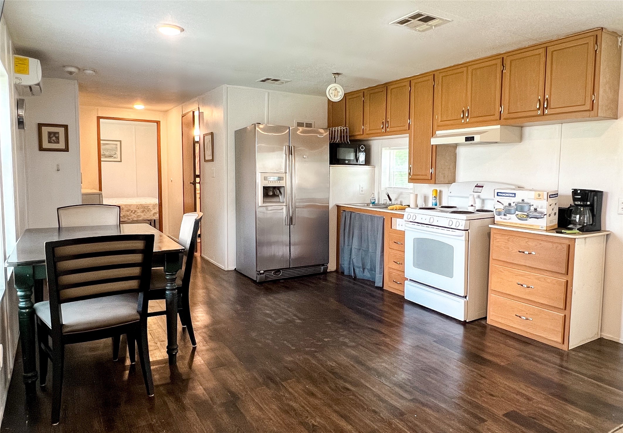 149 Devils Road Goodrich, TX 77335 - Photo 3 of 15 a kitchen with stainless steel appliances wooden floors and wooden cabinets