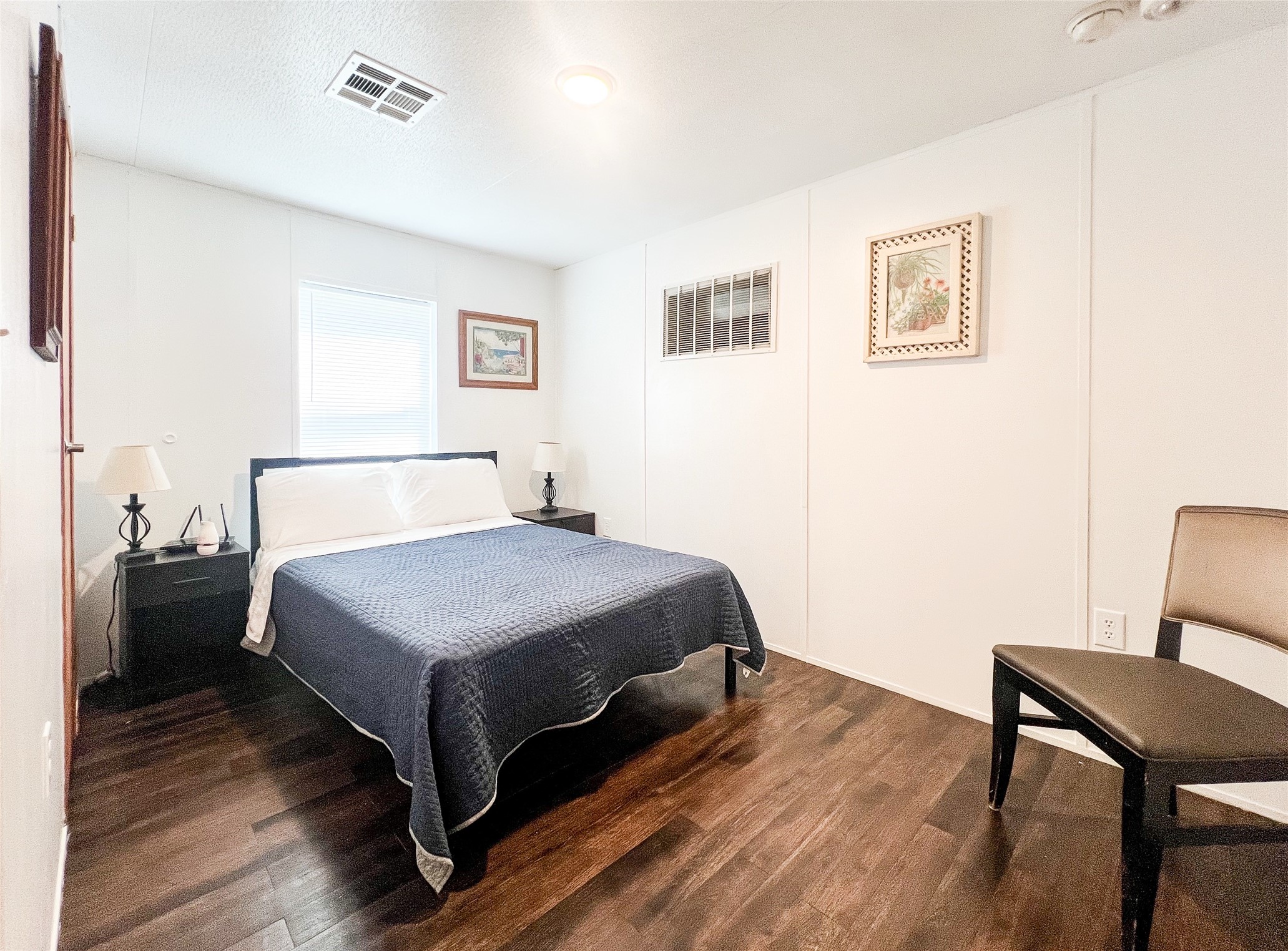 149 Devils Road Goodrich, TX 77335 - Photo 7 of 15 a bedroom with a bed and wooden floor