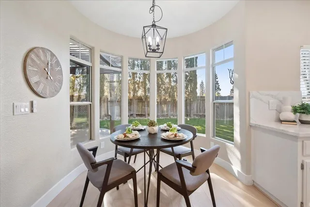 a living room with furniture and a dining table with kitchen view