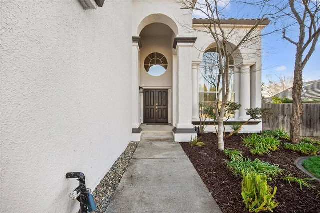 a bathroom with a bathtub and a chandelier