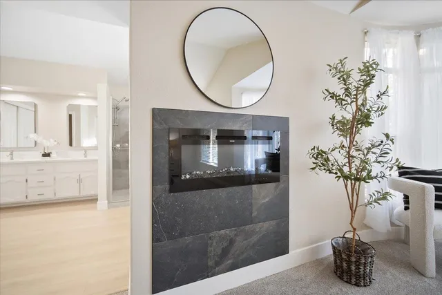 a bathroom with a vase of flowers