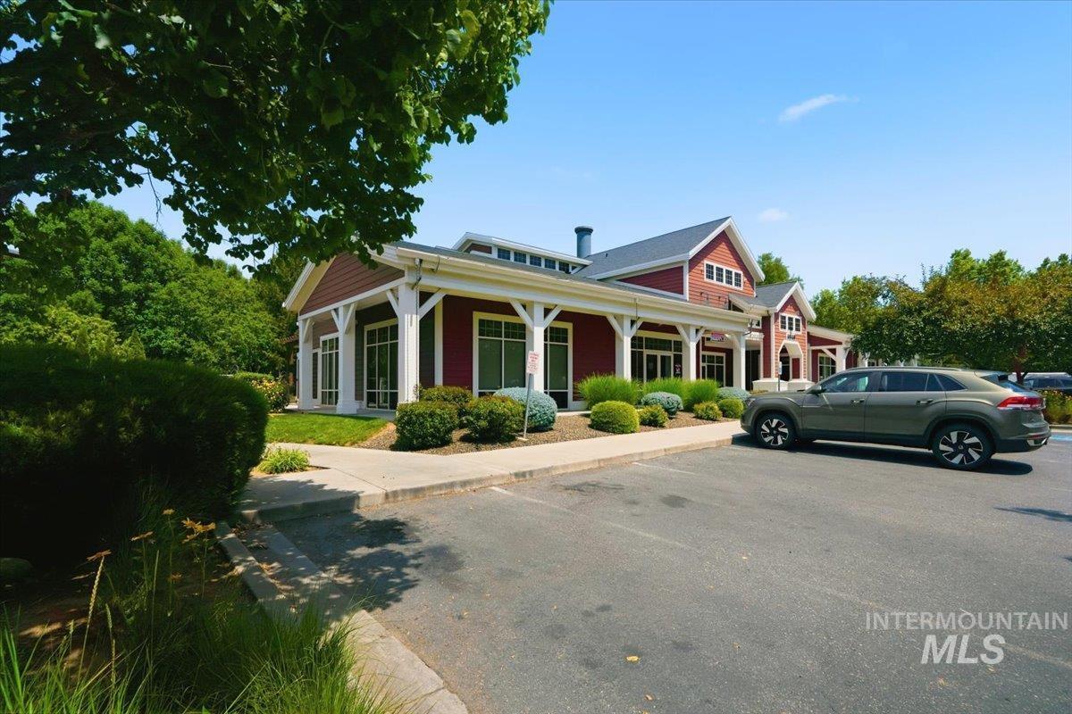 3794 South Single Tree Avenue Boise, ID 83716 - Photo 46 of 50 Two-story building featuring red siding, white trim, a dark gray roof, and prominent white columns