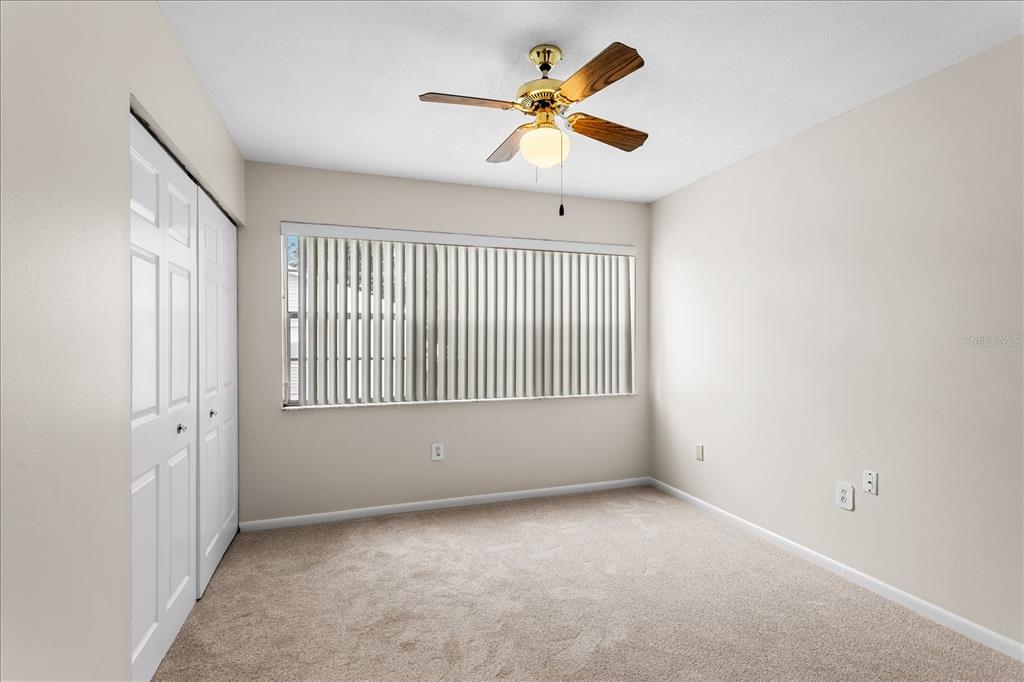 2786 Curry Ford Road, Unit 6B Orlando, FL 32806 - Photo 11 of 27 an empty room with a window and a fan