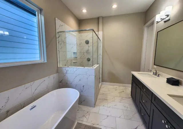 a bathroom with a tub sink and mirror